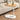 C-shaped sofa end table with a smooth oval wooden top and minimalist design