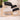 Ergonomic black kneeling chair on floor
