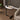Minimalist modern C-shaped coffee table for living room use.