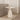 Decorative accent side table with a neutral stone finish.
